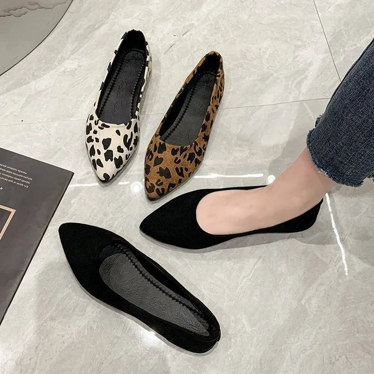 Women's flat pointed toe leopard print pumps with a low heel on a plain background.