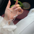 White imitation pearl necklace with bow-shaped pendant on adjustable 31-40 cm chain