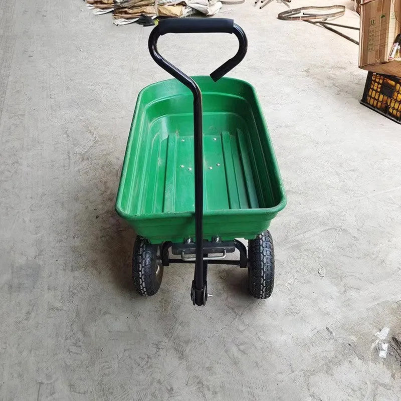 Green four-wheel plastic dump truck with steel PP construction and a tilting cargo bed.