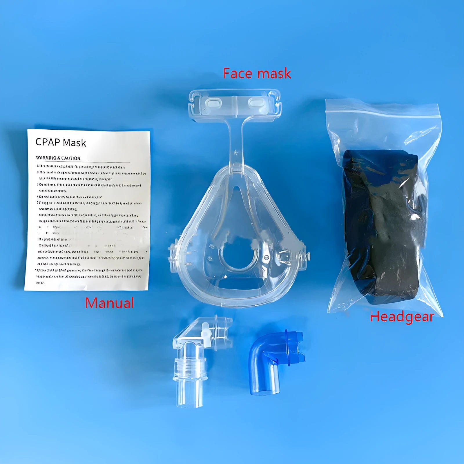 Transparent CPAP breathing mask with silicone cushion, headgear, and adapter elbows