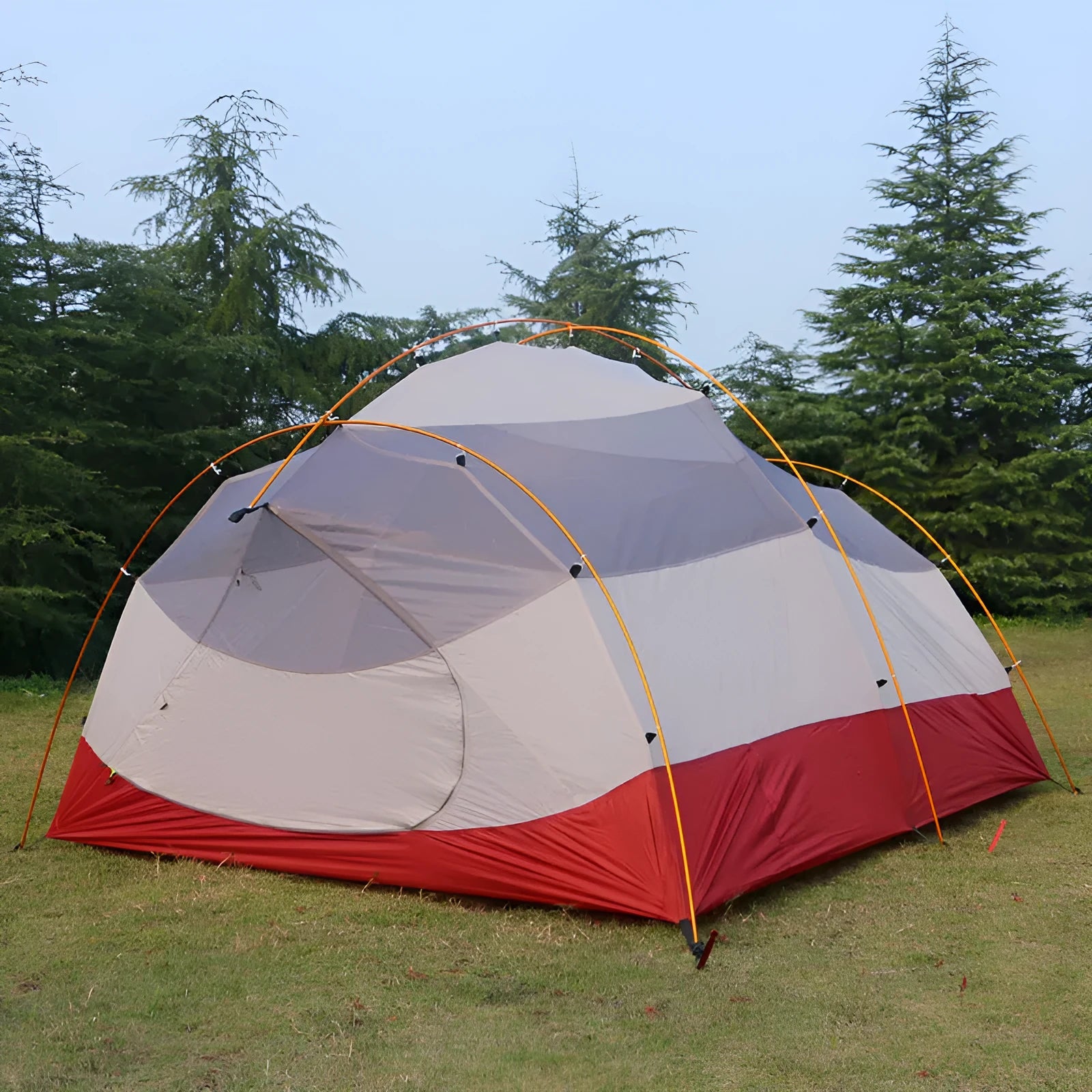 Grey outdoor multi-person tent with aluminum pole and nylon fabric set up on grass