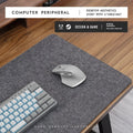 A winter warm felt cork office desk mat in a grey colour pattern, shown on a wooden desk with a mouse.