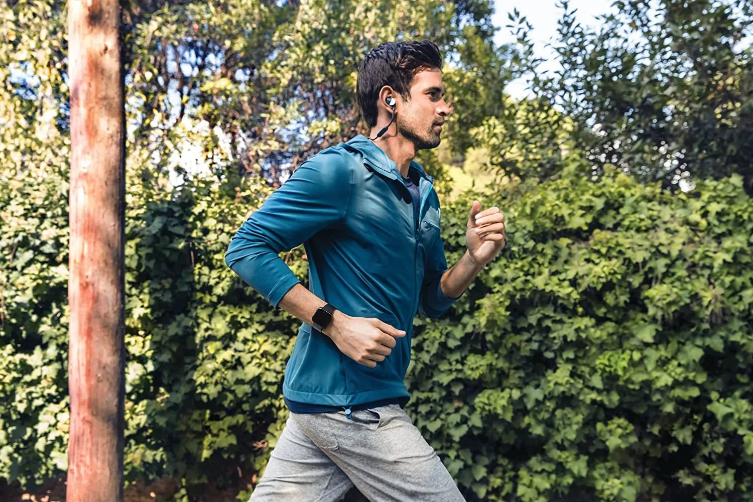 Black smart watch with silicone strap showing heart rate monitoring on its 1.4 inch screen