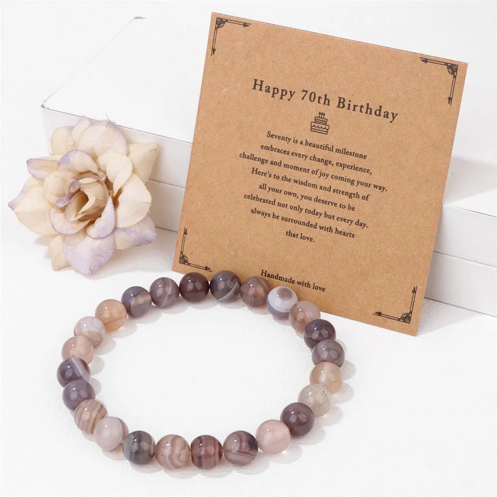 Men's natural stone beads elastic string bracelet 19cm length with birthday card on neutral background