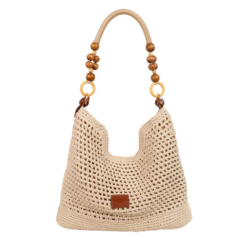 Knitted tote beach bag showing bucket shape, contrast stitching, and zippered internal pocket in black colour