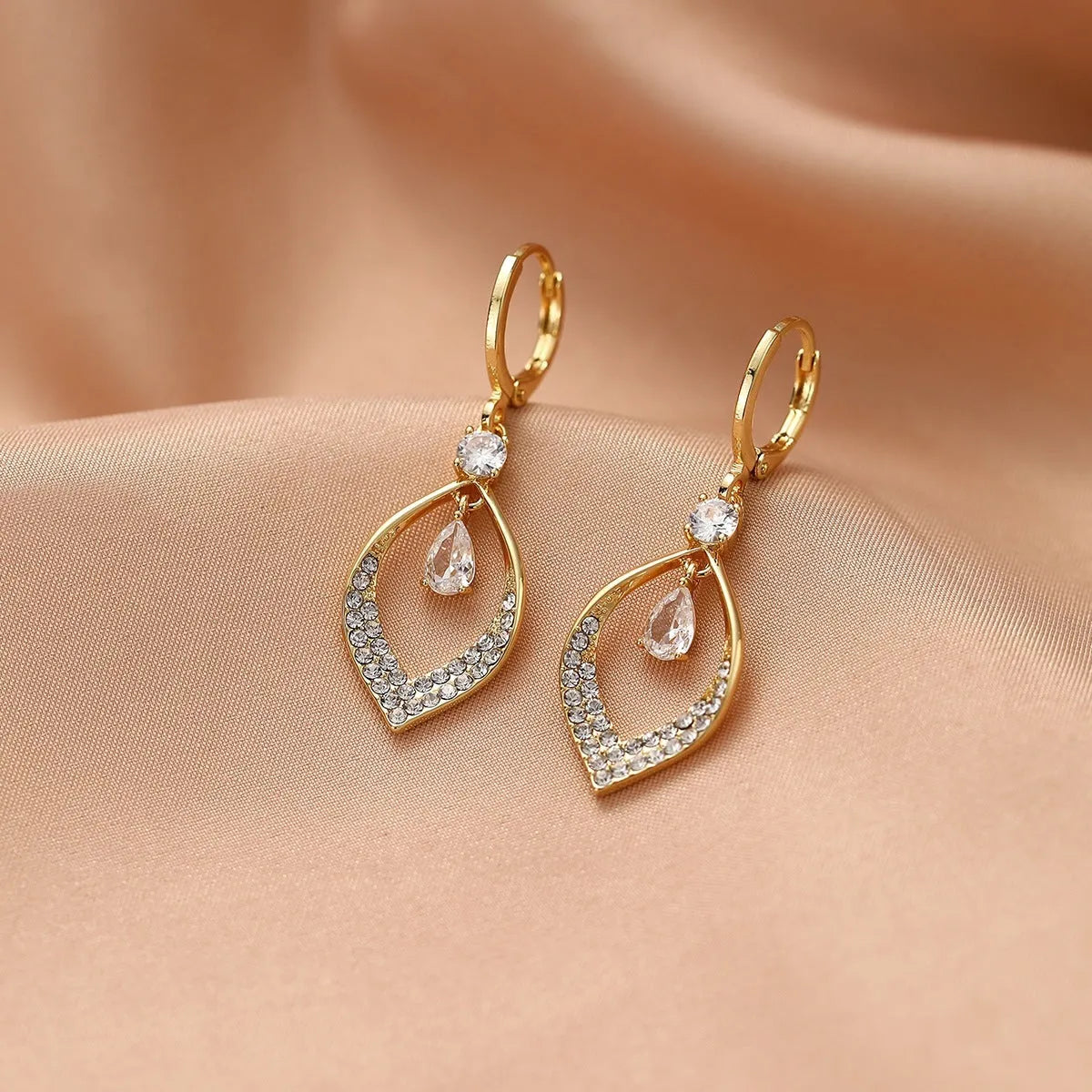 A pair of women's zircon water drop tassel earrings in a teardrop shape with gold-coloured buckles.