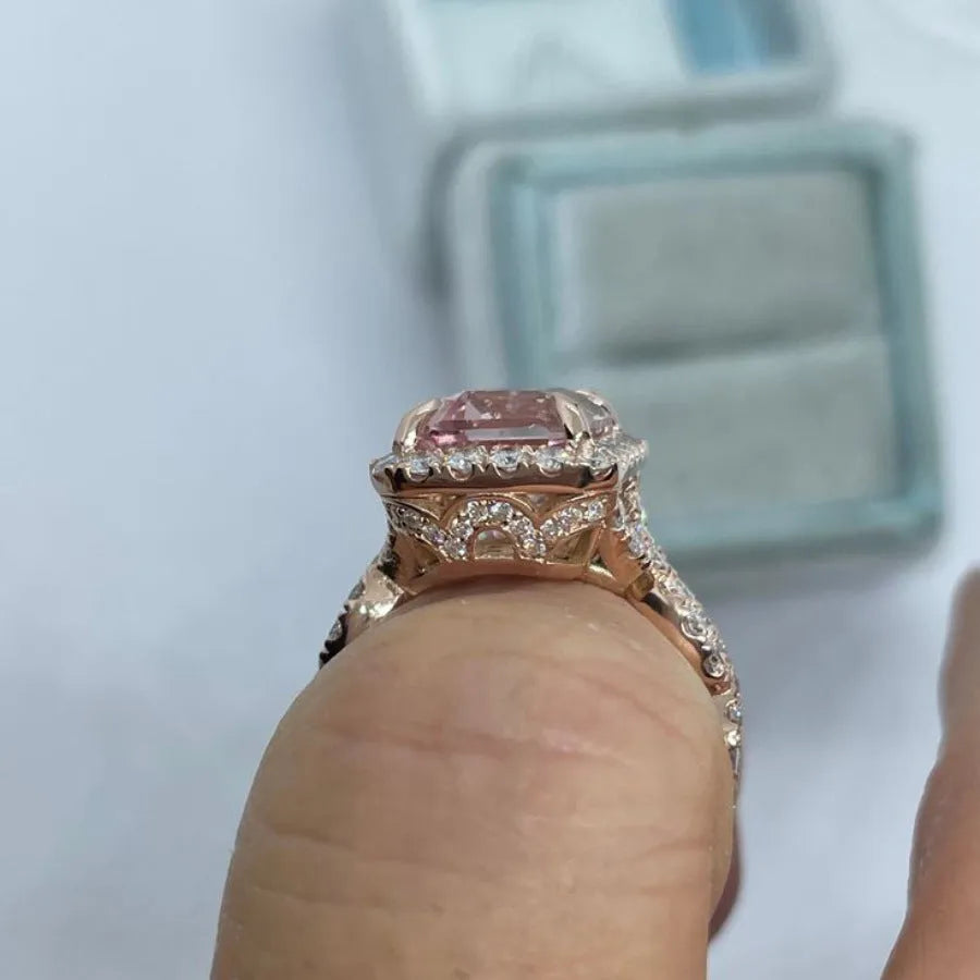 Rose gold geometric alloy ring on a plain background, showing its electroplated finish.