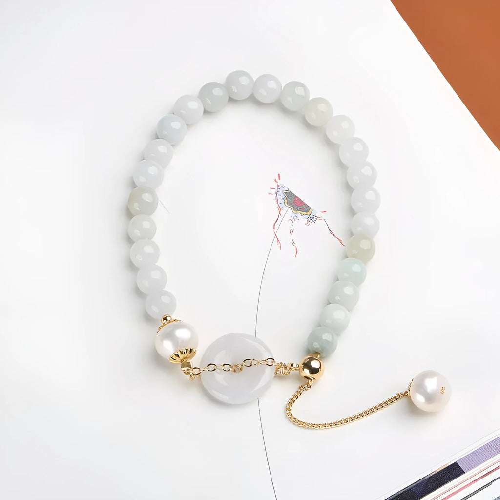 Natural green jade and pearl bracelet with peace buckle closure on wrist