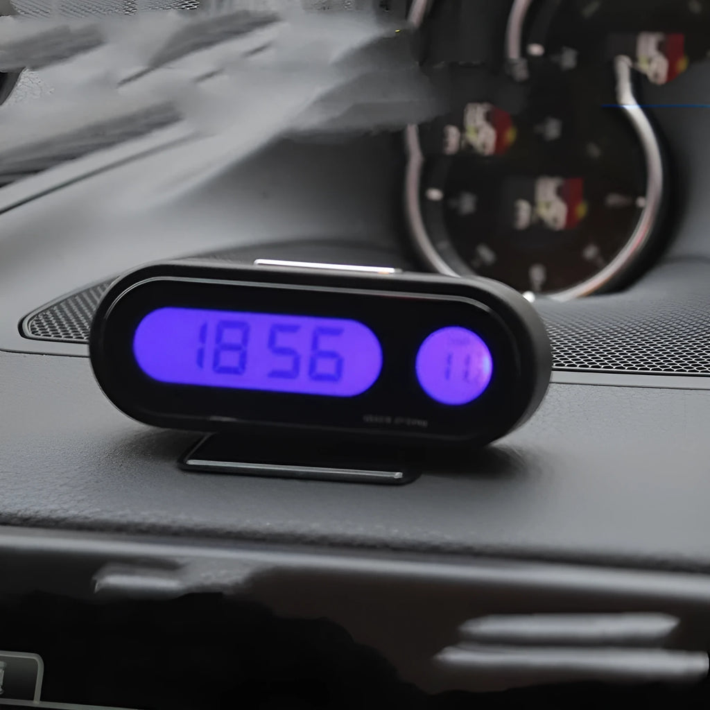 Black car dashboard clock thermometer with digital LED display showing time and temperature