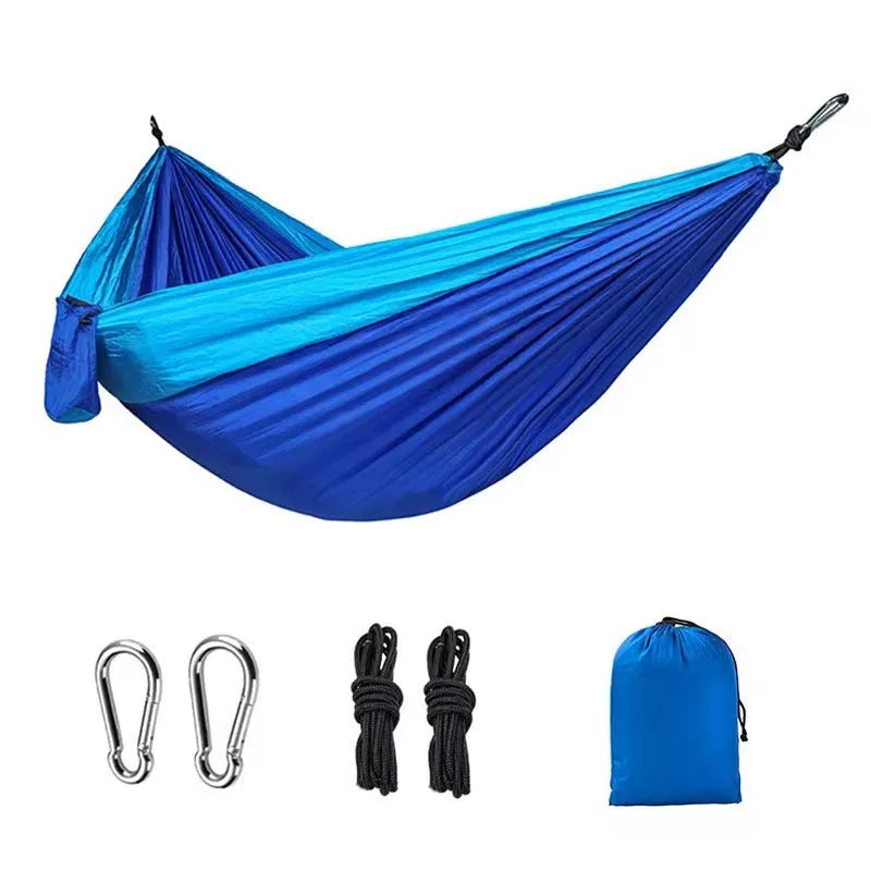 Blue parachute cloth camping hammock hung between trees showing 270cm length