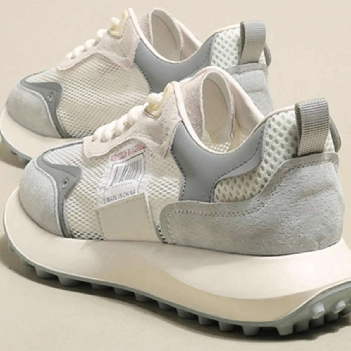 Women's grey and pink low-top retro sneakers with mesh lining and rubber sole
