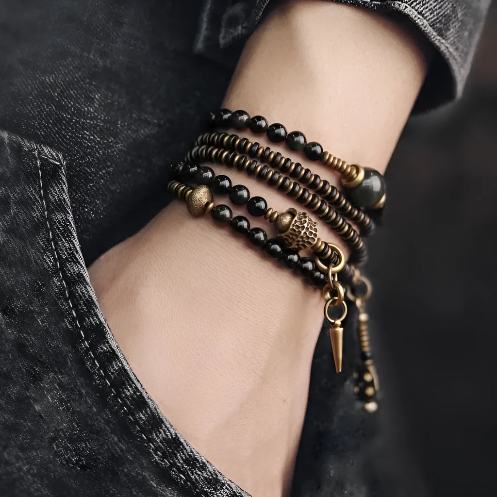 Black multi-layered beaded bracelet with geometric styling on wrist
