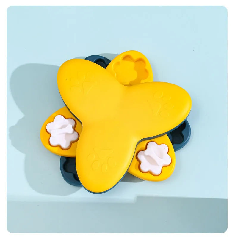 Green and yellow dog puzzle toy with rotatable treat dispenser and nine bone-shaped compartment covers