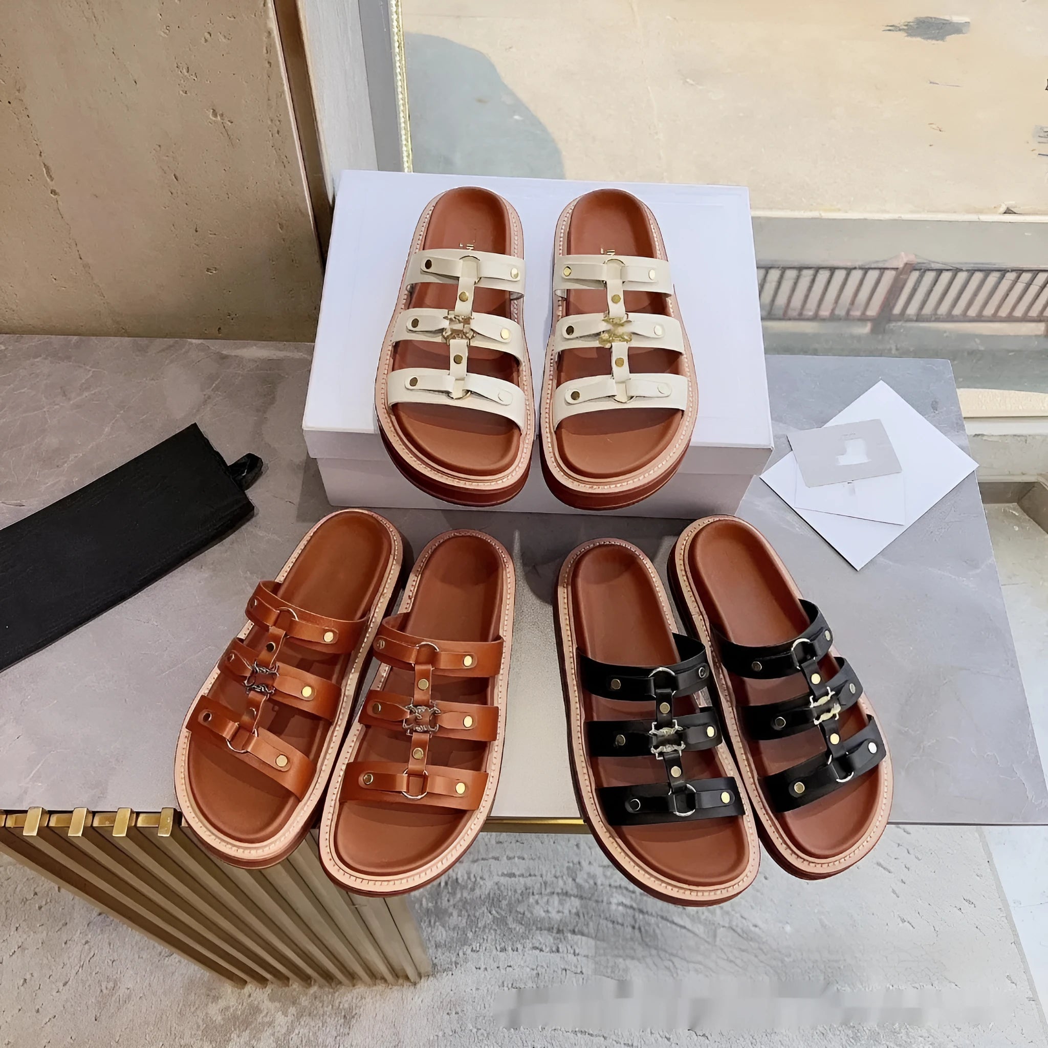 Women's brown retro Roman strap sandal slippers made from sheepskin and patent leather on a wooden floor.