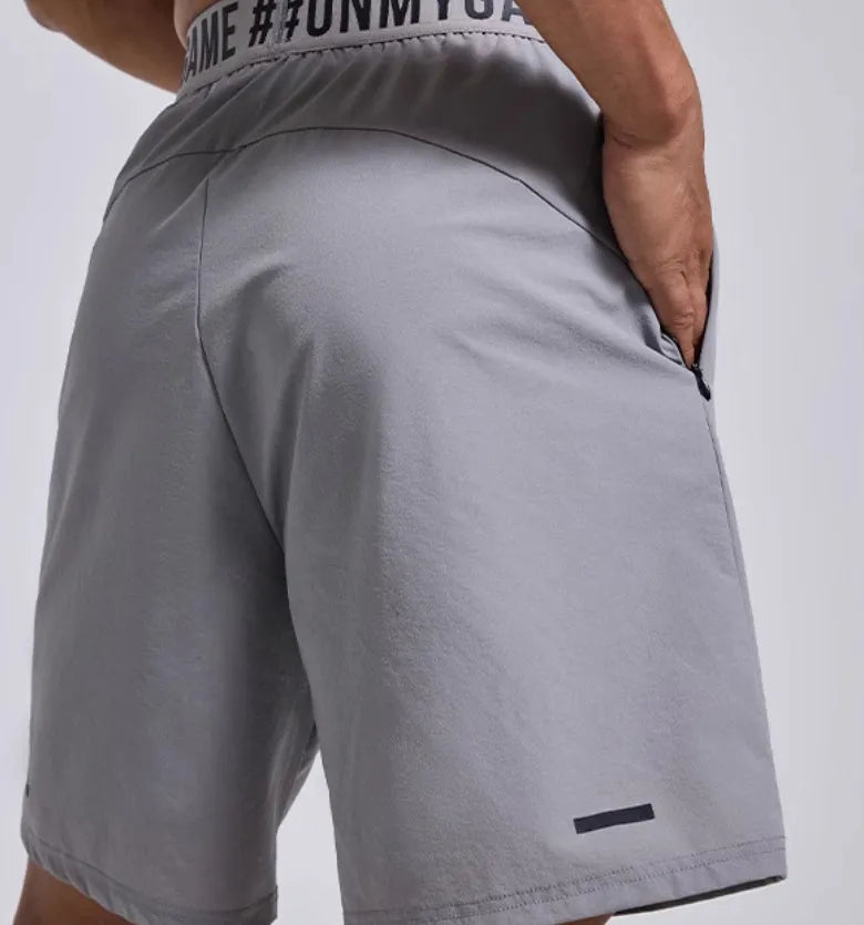 Men's loose sports shorts in black with elastic waist and printed letter details
