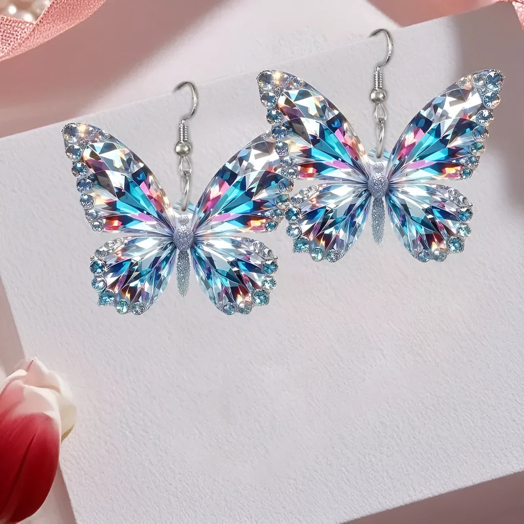 Colourful printed 2D acrylic earrings with butterfly design on a light background