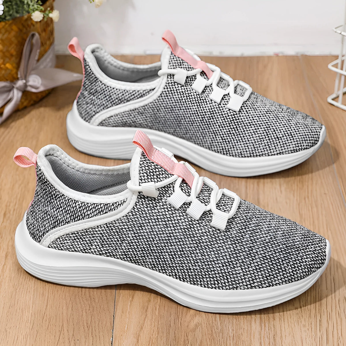 Women's low-top casual sneakers with Flyknit mesh upper in black, pink, or grey with round toe and lace-up front