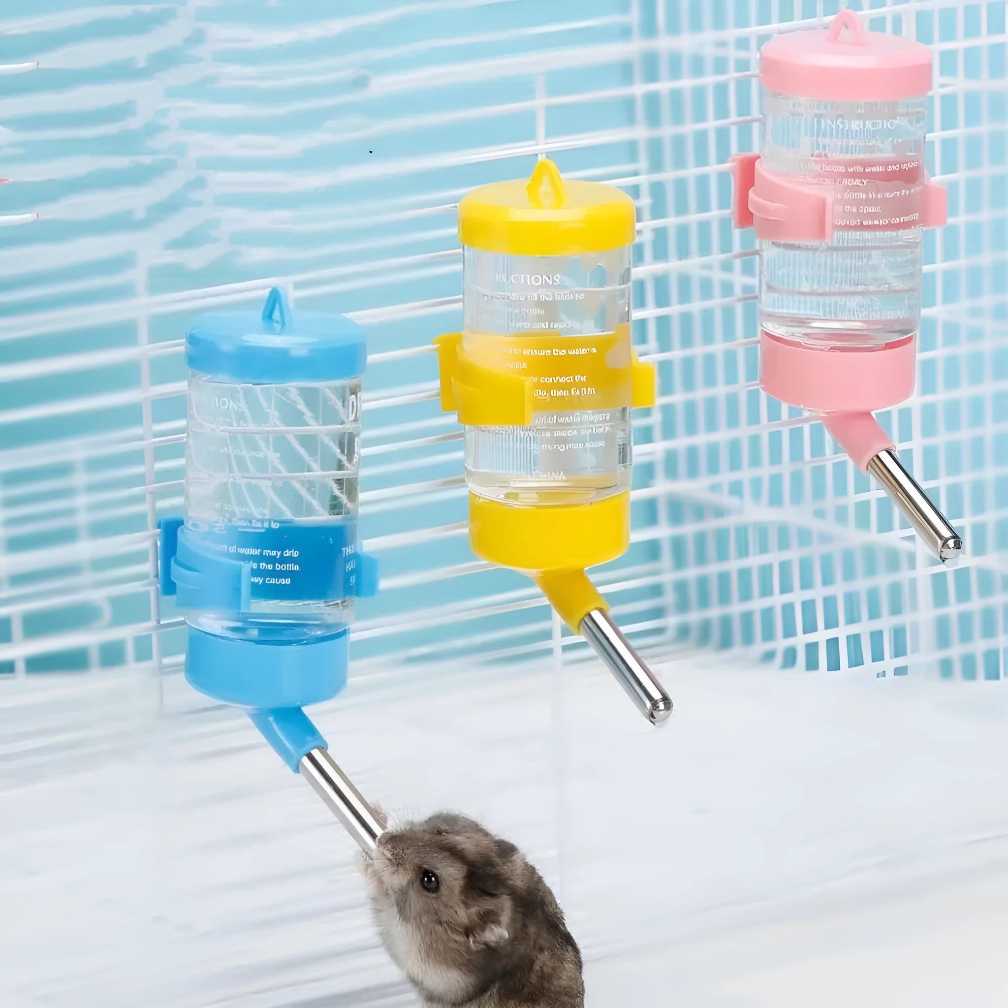 Green plastic ball kettle leak-proof water feeder for small pets attached to a cage, showing the drinking tube.