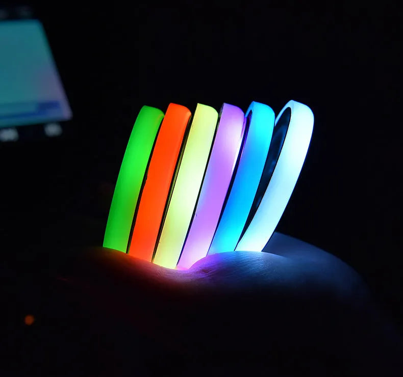 Colourful LED light-up coaster for car cup holder with solar panel and USB port.