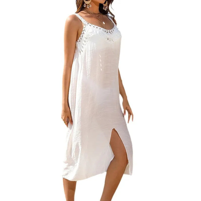 White women's suspender beach dress with hollow crochet detail and a side slit