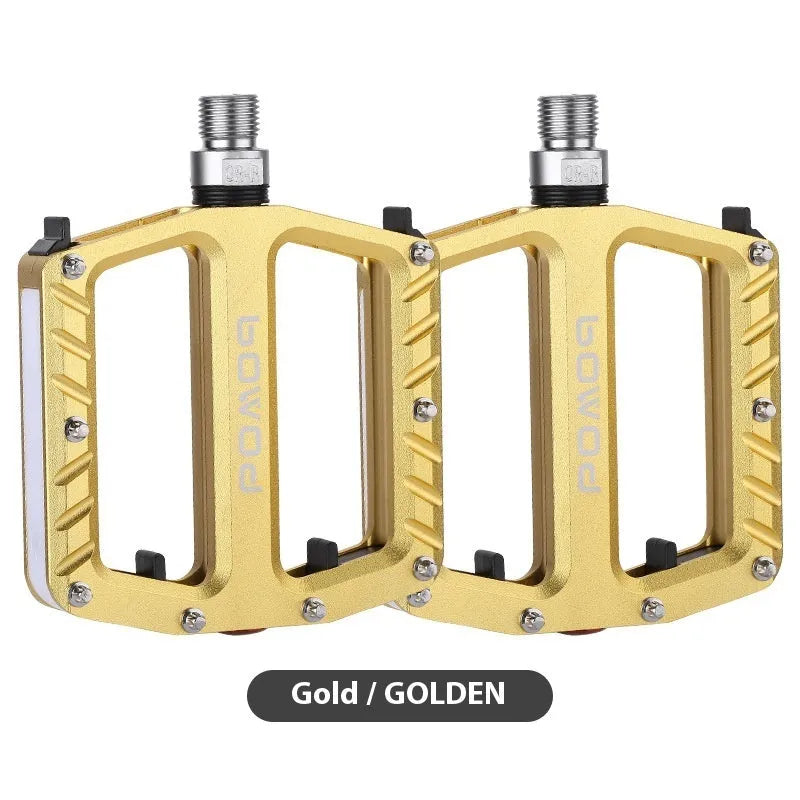 Pair of aluminium alloy bicycle pedals with integrated LED lights in multiple colour options.
