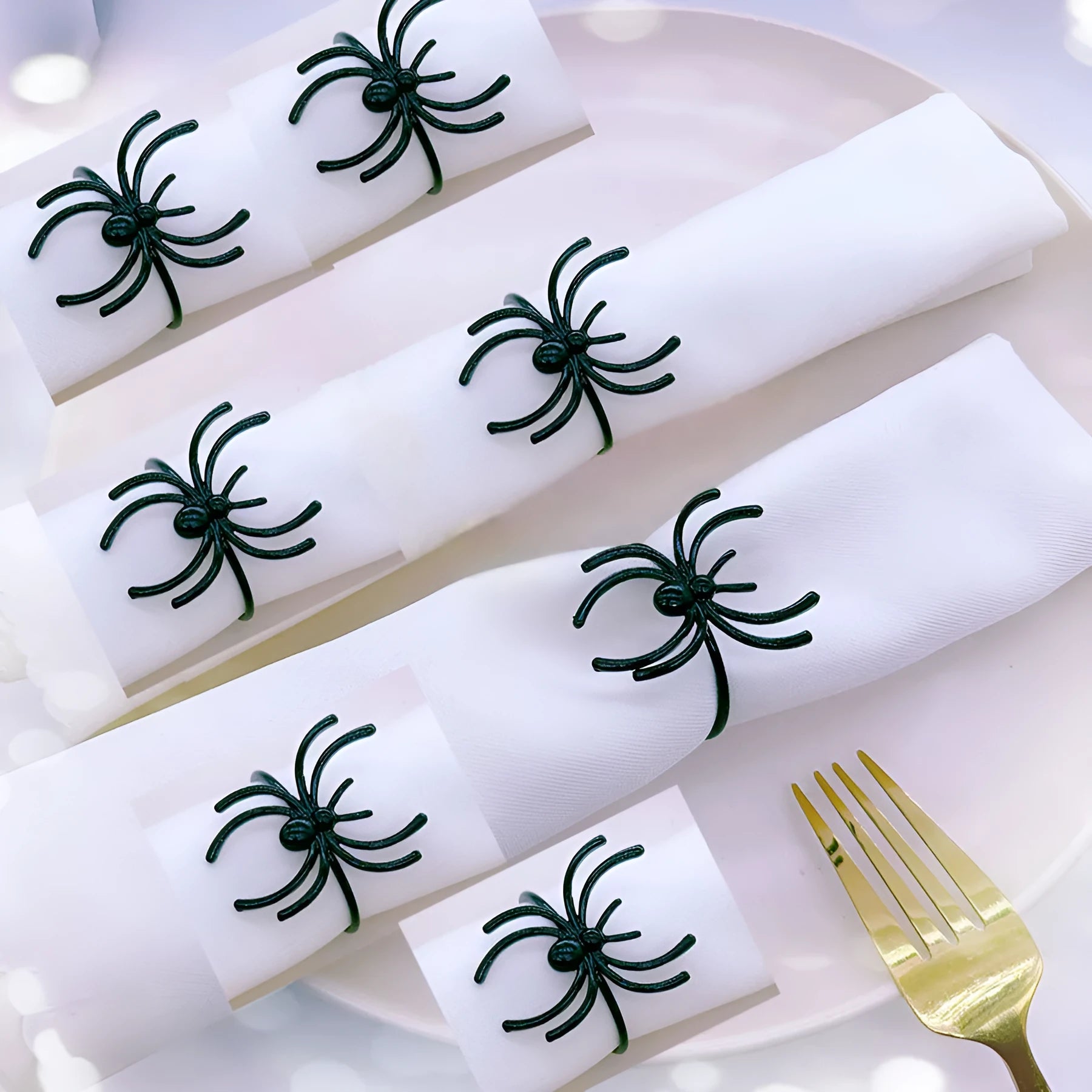 Six black spider-shaped alloy napkin rings for Halloween table decoration.