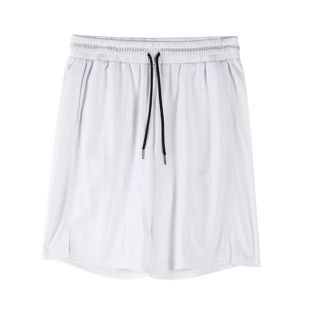 Man wearing loose black capri-length fitness shorts with an elasticated waistband.