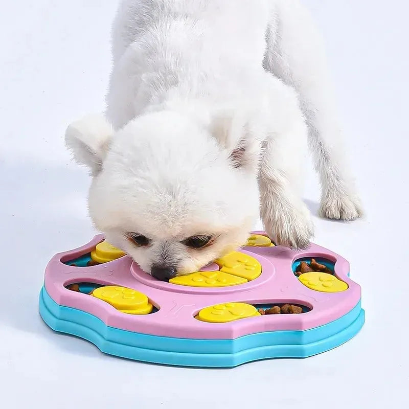 Blue and pink dog puzzle toy feeder bowl for aggressive chewers on a wooden floor.
