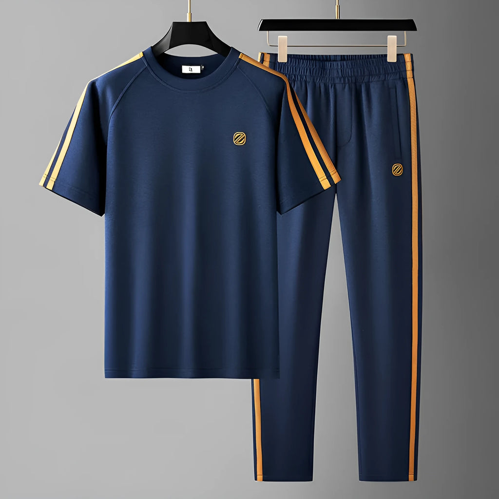 Man wearing a blue ironing-free polyester sports suit set with short sleeves and matching trousers.
