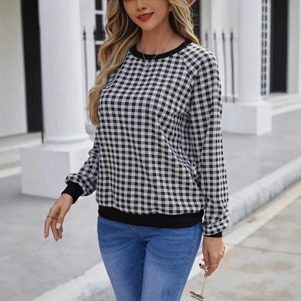 Black long sleeve pullover sweater with plaid stripes and printed pattern on a mannequin.