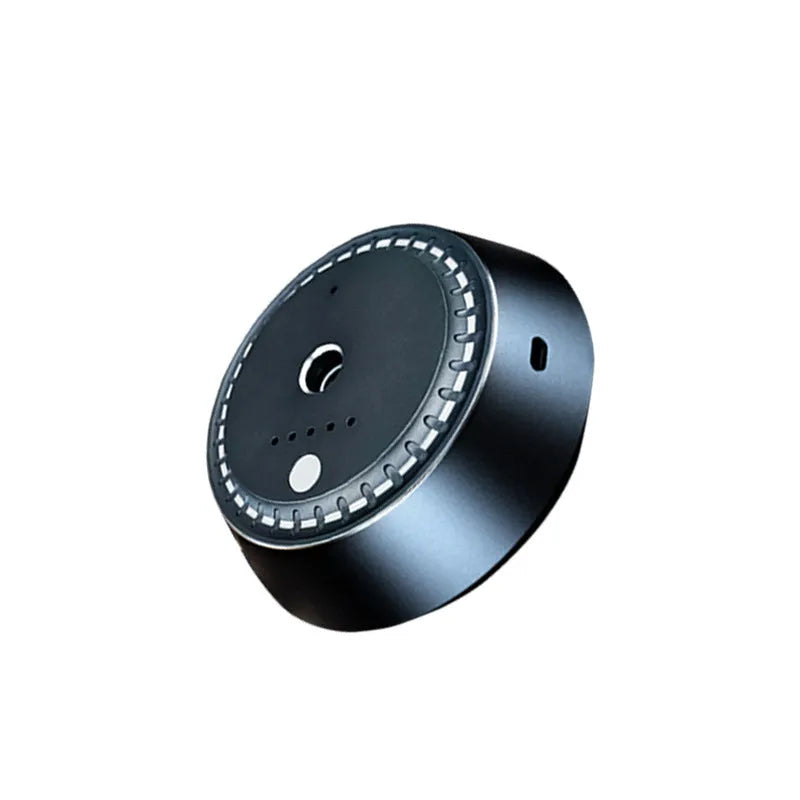 Black metal USB rechargeable car aroma diffuser with 30ml tank on a car dashboard.