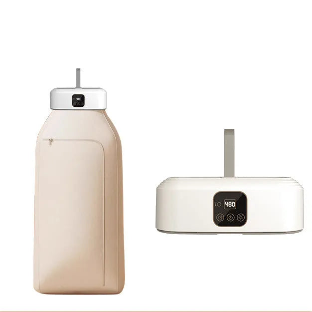 White cylindrical compact laundry drier with remote control on countertop