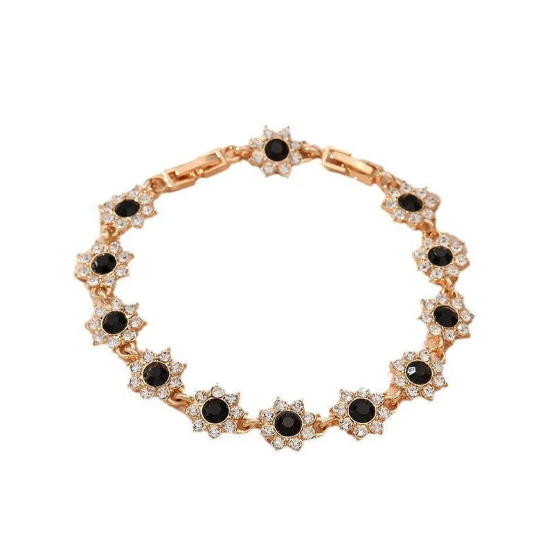 Electroplated zinc alloy flower bracelet with coloured gems in gold and silver colour options