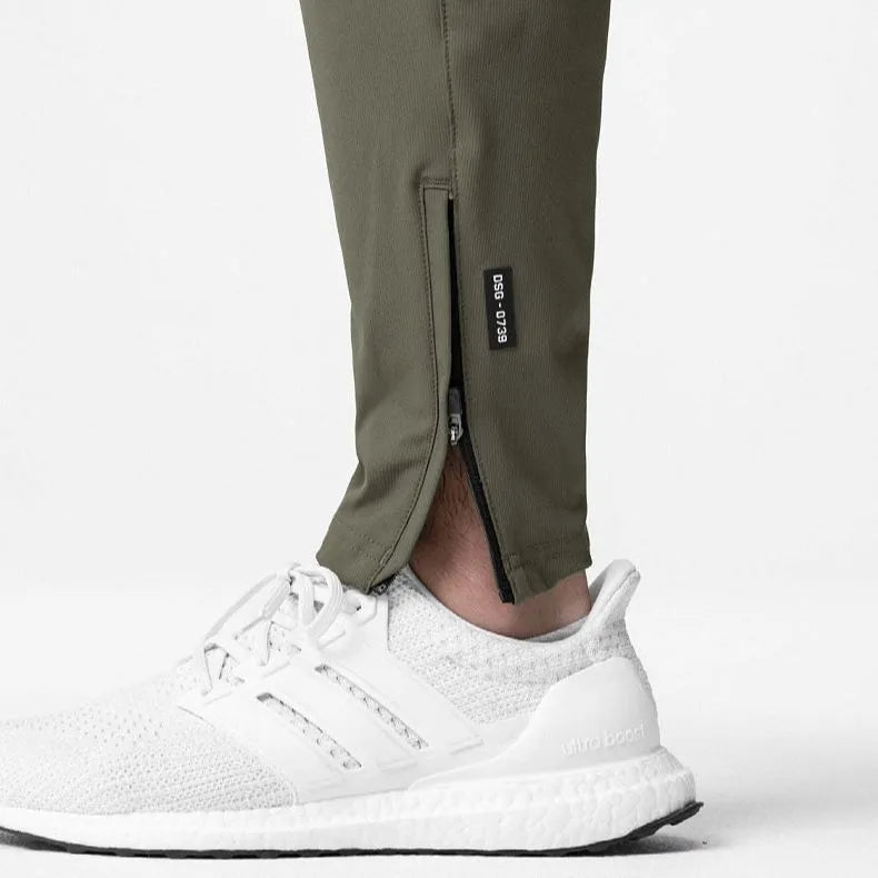 Men's dark grey quick-dry ankle-tie fitness pants shown in a loose fit.