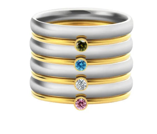 Engraved geometric titanium steel ring with December birthstone colour and layered design on a grey background