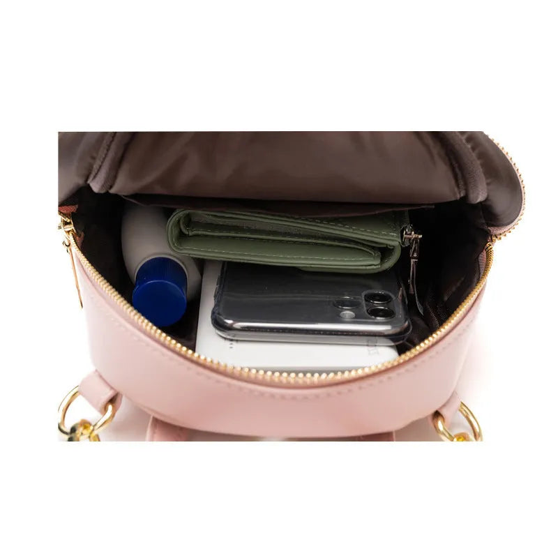 Soft PU mini backpack in street style with a three-dimensional front pocket, shown in multiple colour options.