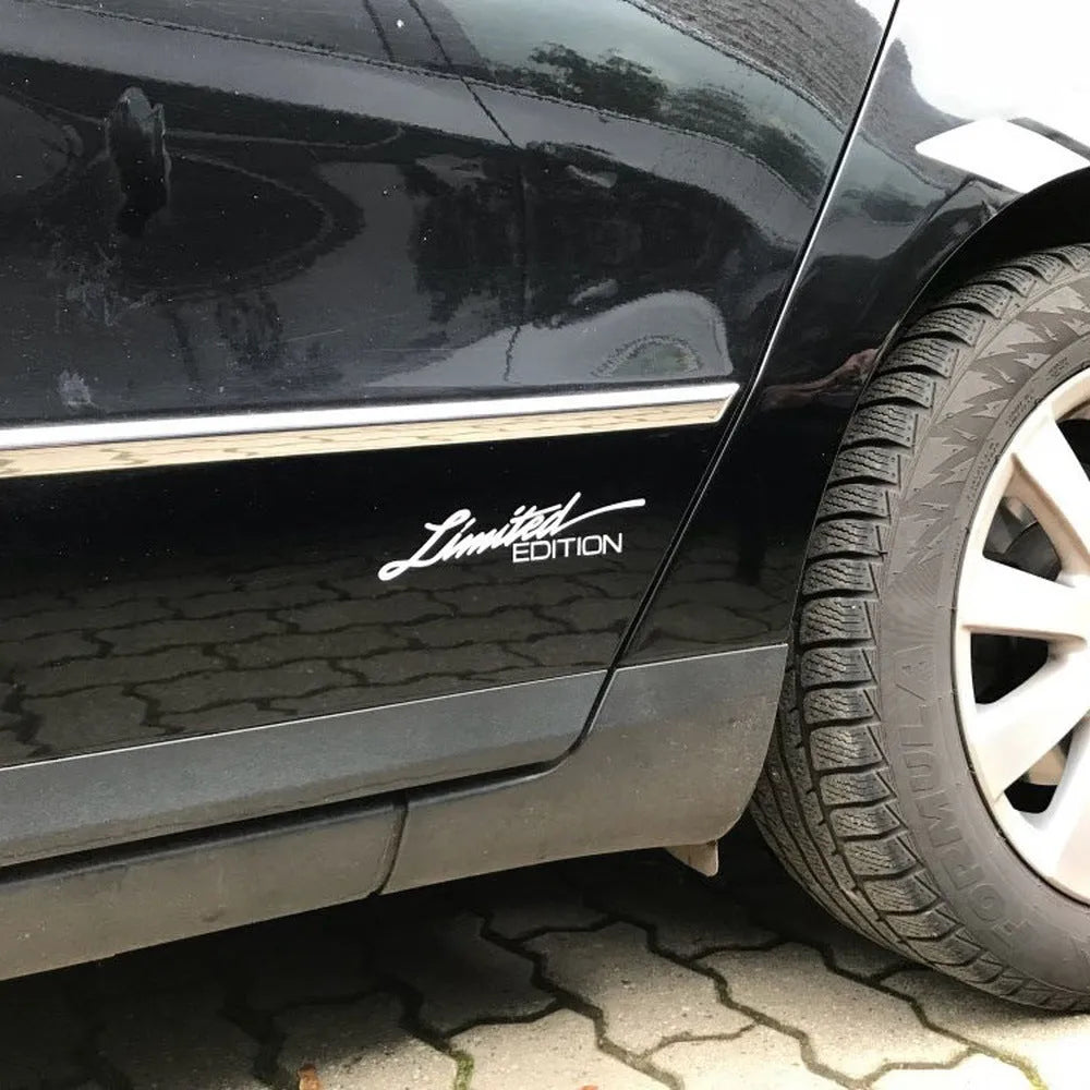 British reflective plastic bumper sticker shown in black, white and colourful variants, dimensions 16cm by 3.8cm.
