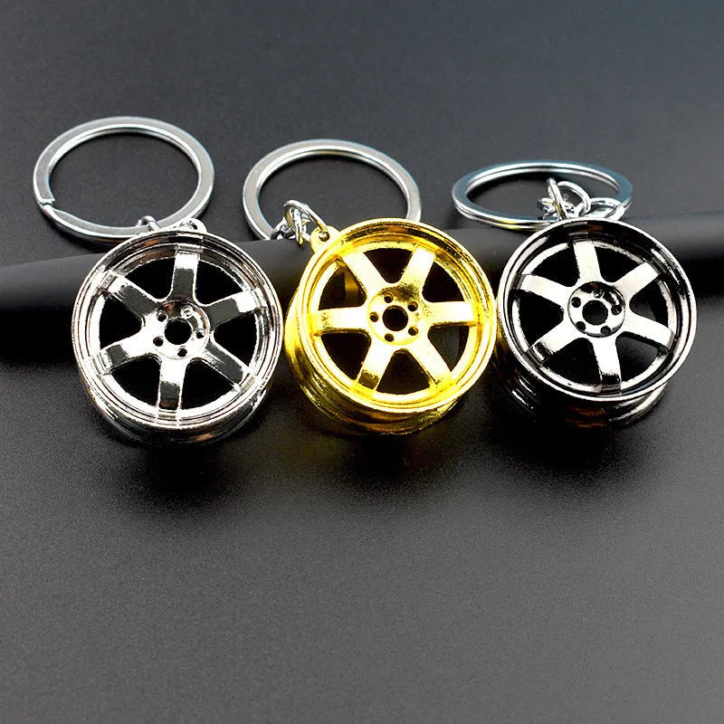 Creative car modification wheel hub metal keychain in gold finish on a keyring