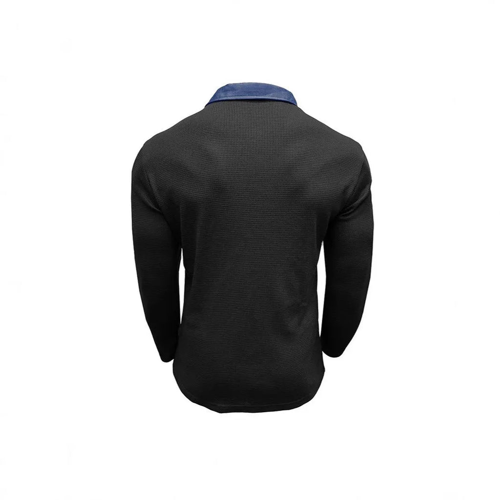 Man wearing a loose-fit long-sleeved polo shirt with a waffle knit texture in a dark blue colour.