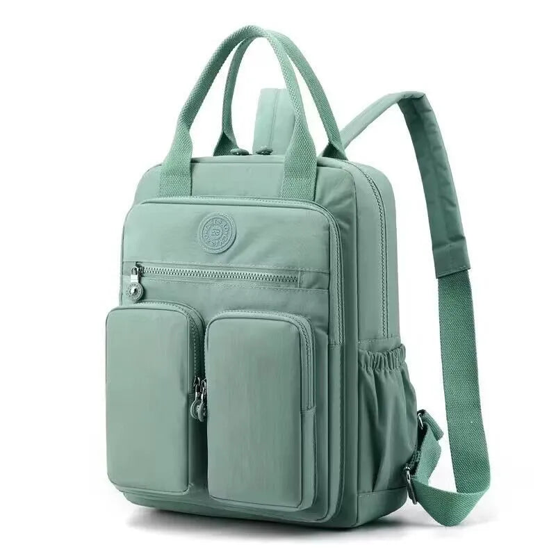 Large soft nylon waterproof backpack in grey, open to show internal laptop, camera, and phone compartments.
