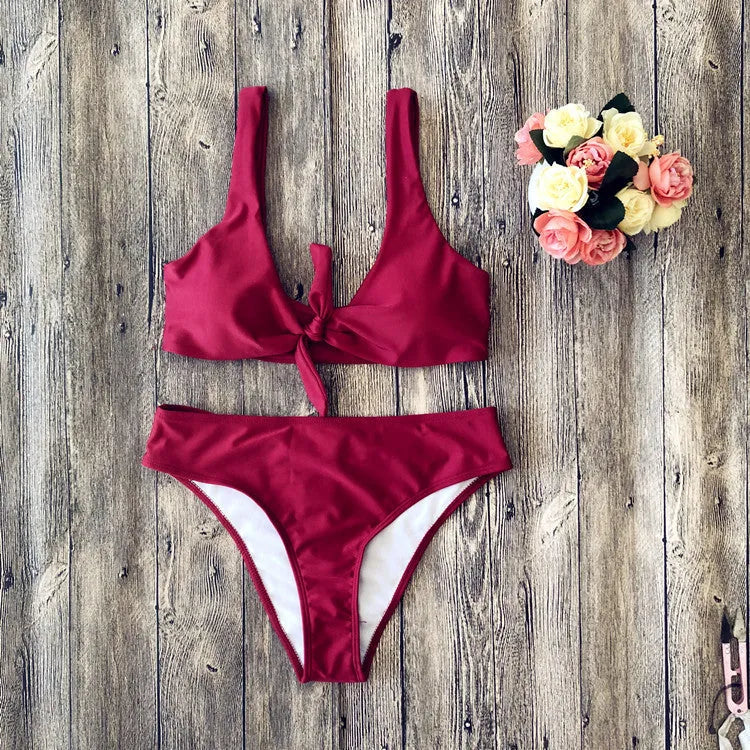 Solid colour bikini set on hanger, showing bra top and briefs in black, pink, red, white, or wine red.