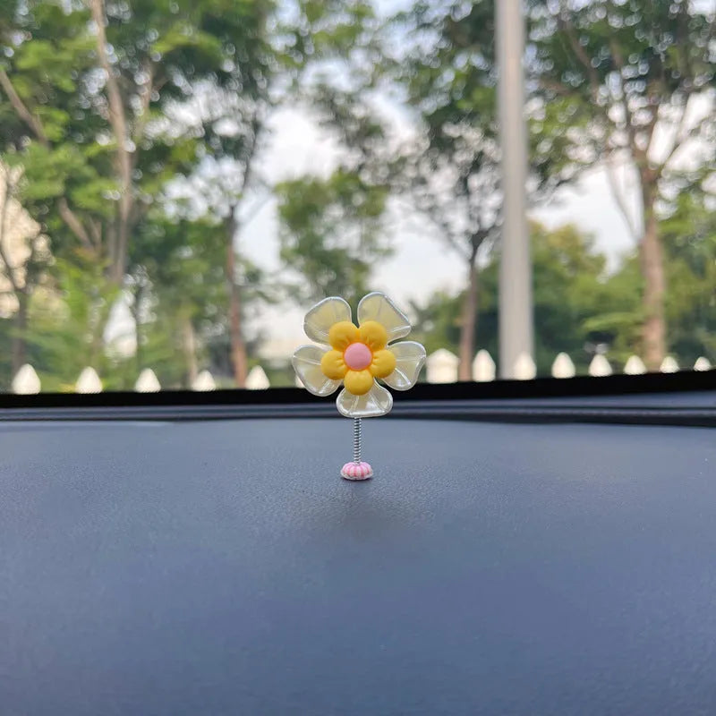 Small blue plastic swing-shaped car dashboard decoration.