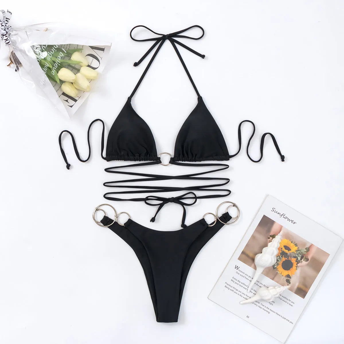 Black women's bikini set with metal ring straps and a backless, high cut leg design