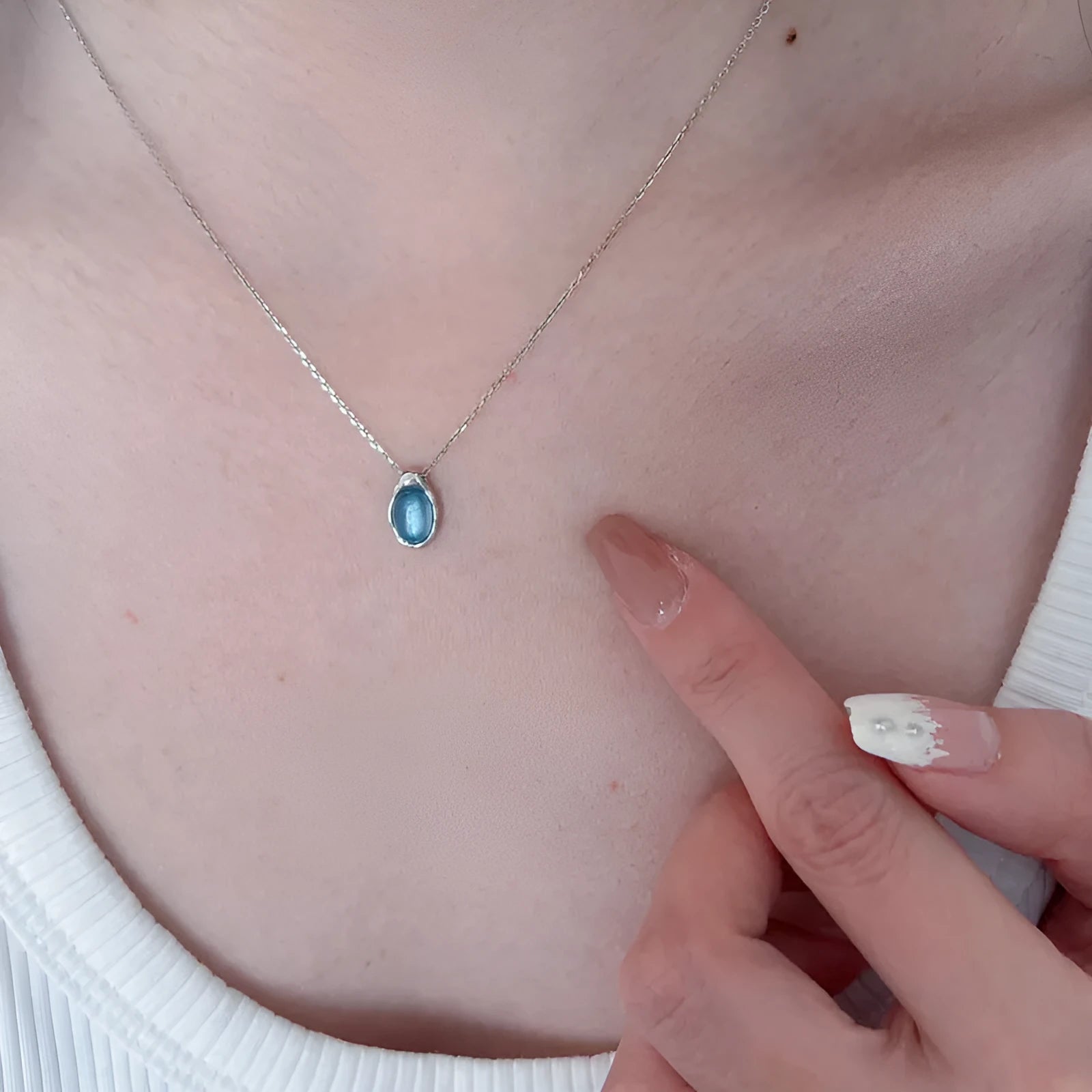 Women's navy blue water drop necklace with geometric pendant on adjustable cross chain