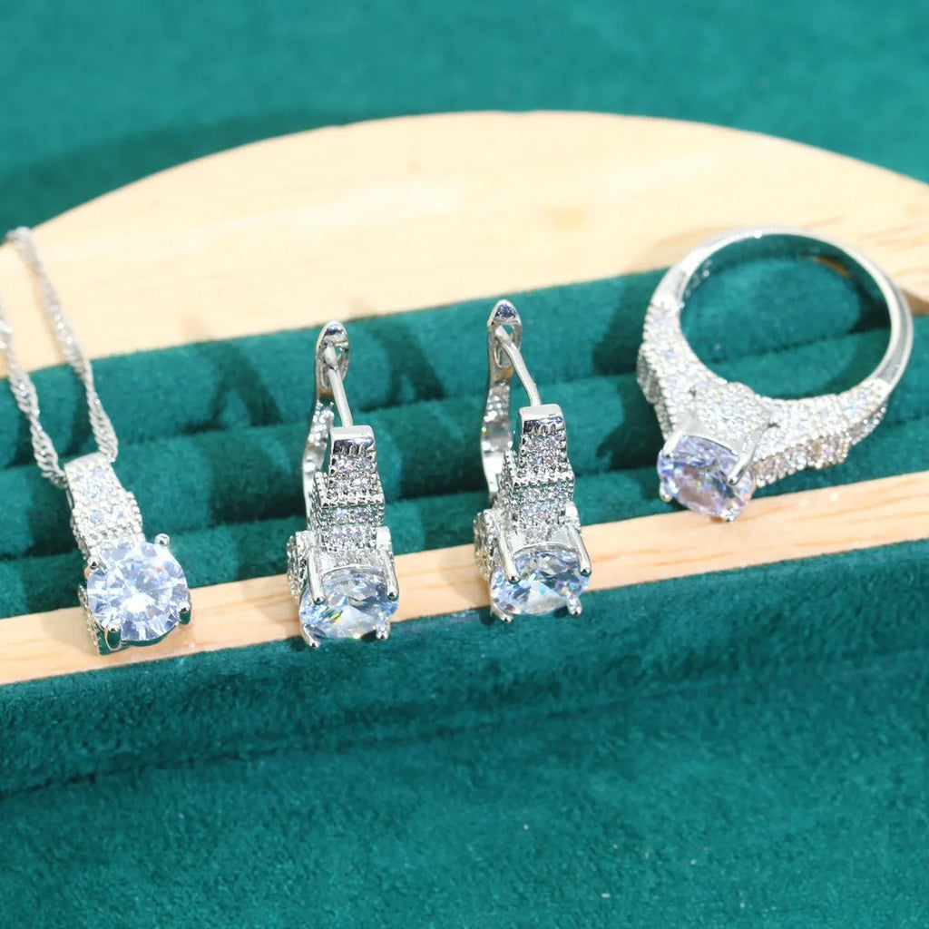 Bridal zircon necklace, bracelet, earrings, and ring four-piece jewellery set in alloy with water wave chain design.