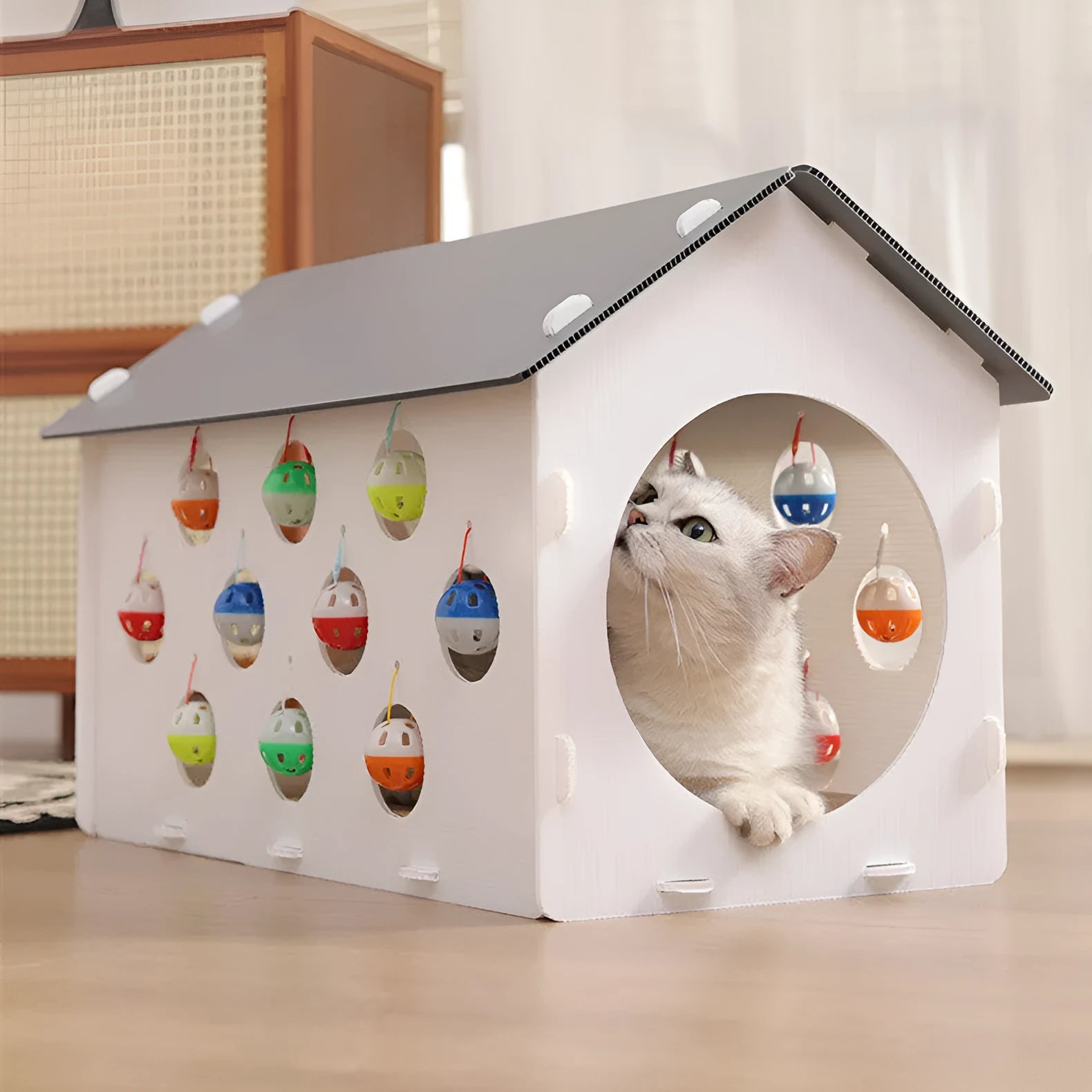 Integrated cat scratch board with attached tunnel containing bell ball and combined pet bed area