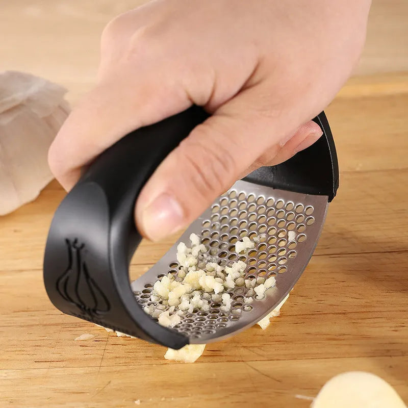 Stainless steel garlic press with coloured handle in green, pink, black, or blue option