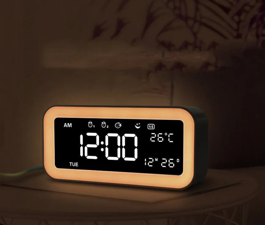 Blue rectangular LED multicoloured atmosphere light alarm clock with digital display on a desk.