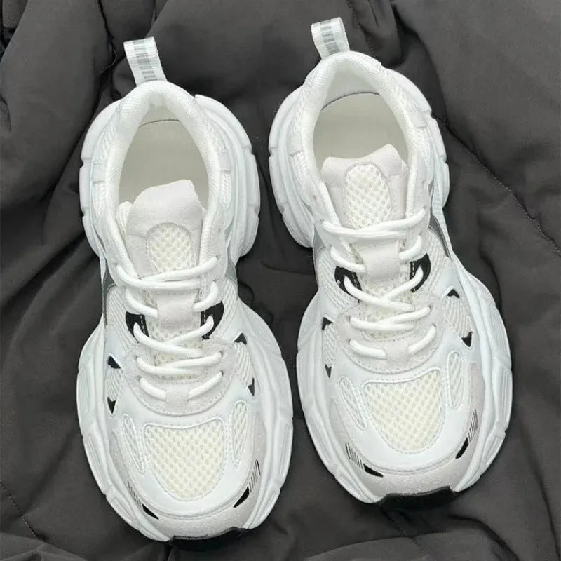 Beige mesh platform sports shoe with a wedge heel and front lace-up design on a white background.