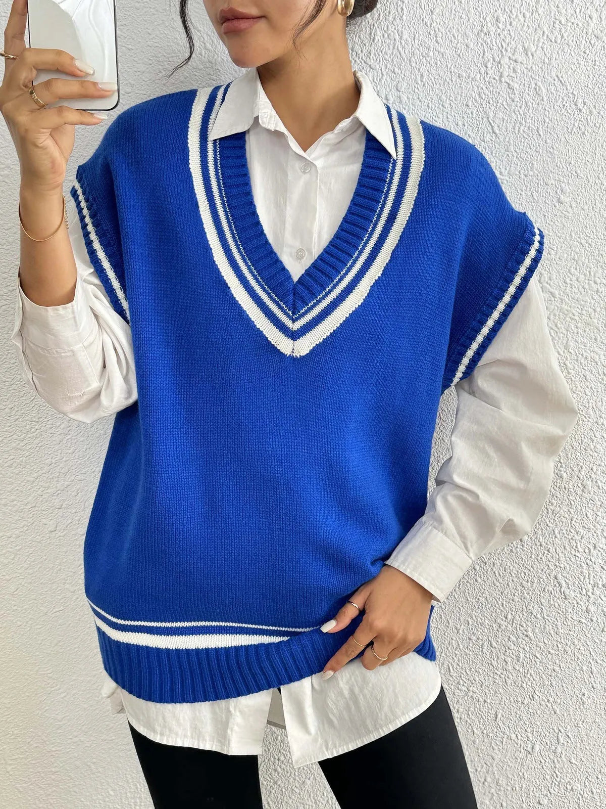 A loose-fit women's vest sweater in a college style, shown in a choice of colours.